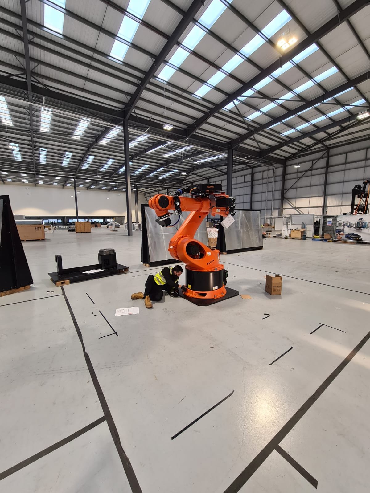Six-axis industrial robot being installed in a new manufacturing cell